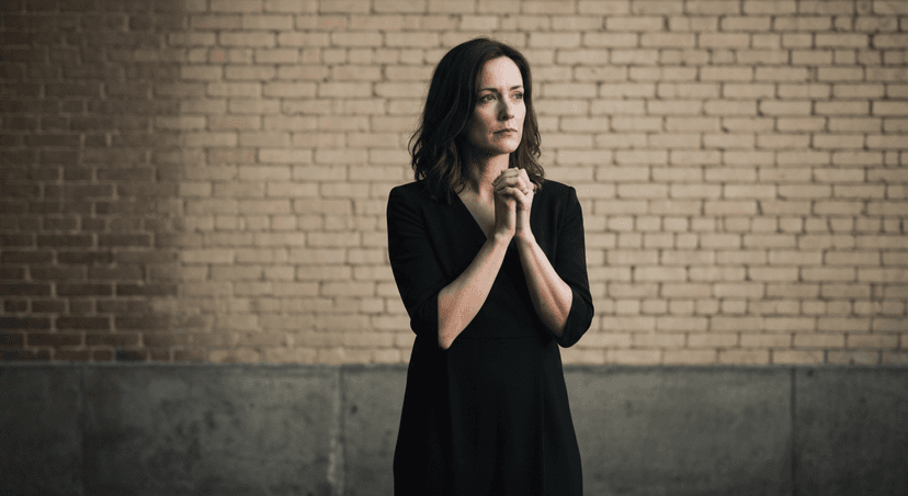 A row of diverse people of varying heights silhouetted against a sunset sky